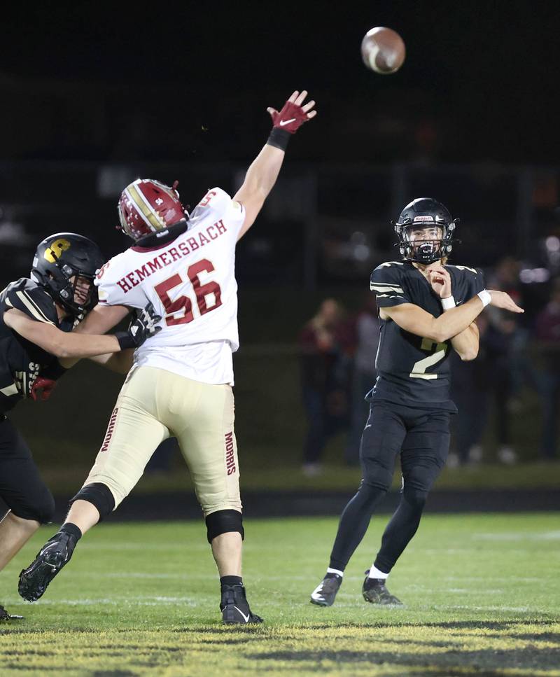Sycamore's Elijah Meier throws a pass over the outstretched arm of Morris' Justin Hemmersbach during their game Friday, Oct. 21, 2022, at Sycamore High School.