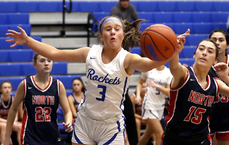 Burlington Central's Savannah Scheuer battles with Belvidere North's Camryn Diercks for a rebound on Monday, Nov. 13, 2023, during pool play girls basketball game in the Burlington Central Mark Einwich Tournament.