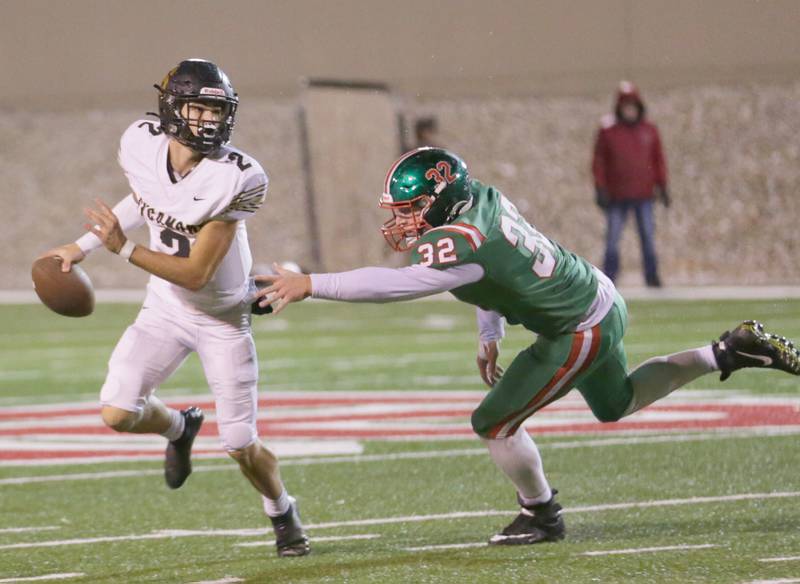 Sycamore's quarterback Elijah Meier (2) avoids a sack from L-P's Connor Lorden (32) on Friday, Oct. 14, 2022 at Howard Fellows Stadium in Peru.