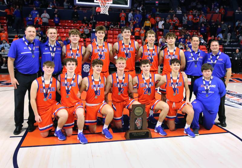The Eastland basketball team with the state runner-up trophy after their IHSA Class 1A state championship loss to Chicago Hope Academy Saturday, March 15, 2025, in the State Farm Center at the University of Illinois in Champaign.
