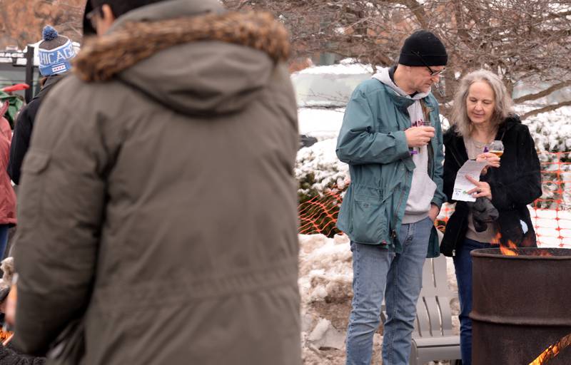 Matt and Patty Wisz of Downers Grove look over the beer list while attending the Westmont Park District's Winter Beer Festival Saturday, Feb. 15, 2025.