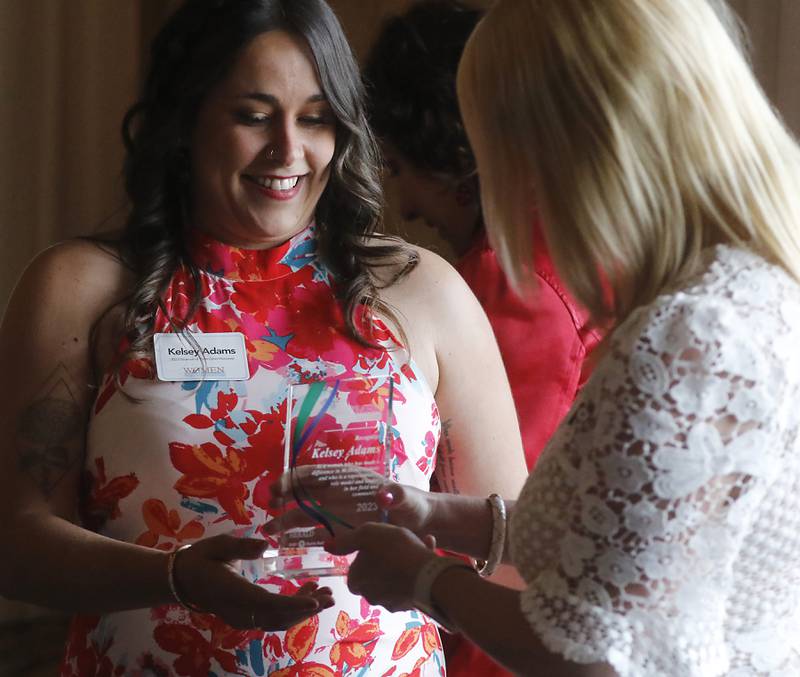 Award recipient Kelsey Adams receives her award from Laura Shaw of Shaw Media,  during the Northwest Herald's Women of Distinction award luncheon Wednesday June 7, 2023, at Boulder Ridge Country Club, in Lake in the Hills. The luncheon recognized 10 women in the community as Women of Distinction.