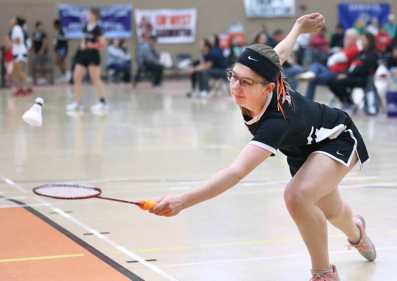 DeKalb junior Carly Kammes stretches for a shot during her match against Dana Bogda, a senior from Lincoln-Way West Friday, May 10, 2024, during the IHSA State Badminton Finals at DeKalb High School. Kammes was able to advance after defeating Bogda.