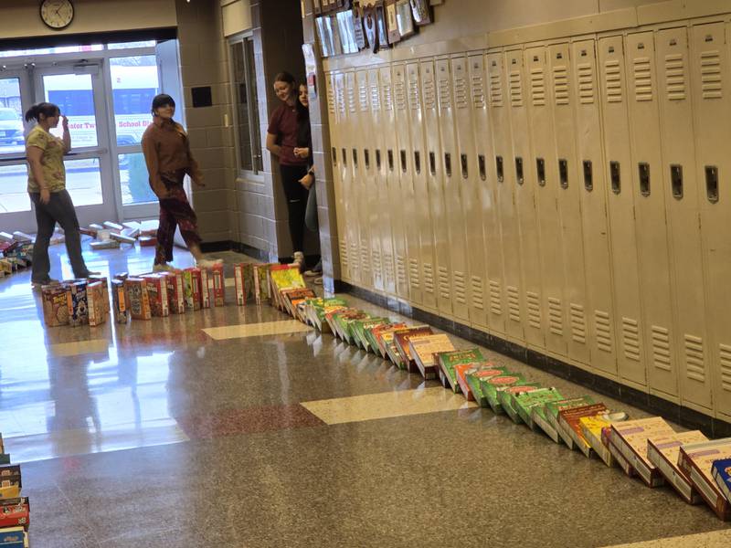 The cereal box dominoes come close to their finish Tuesday, March 18, 2025, in the hallways of Streator High School.