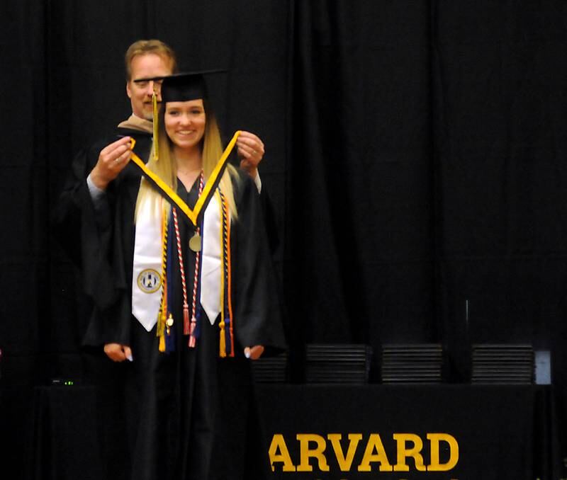 Abigail Jean Tittle receives her honors medal from Harvard Principal Cary Hobbs Sunday, May 22, 2022, during the Harvard High School Commencement Ceremony in Harvard .