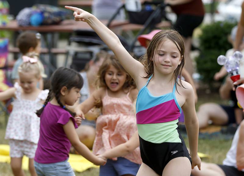 Children dance to the music of the Being Bilingual Rocks (BBR) Band as they perform during the Crystal Lake Park District and Public Library's Summer Singalong for Kids on Friday, June 21, 2024, at Crystal Lake's Main Beach.