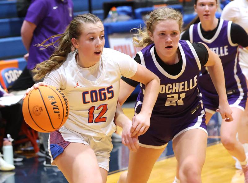 Genoa-Kingston's Ally Poegel drives by Rochelle's Abby Metzger during their game Monday, Dec. 16, 2024, at Genoa-Kingston High School.