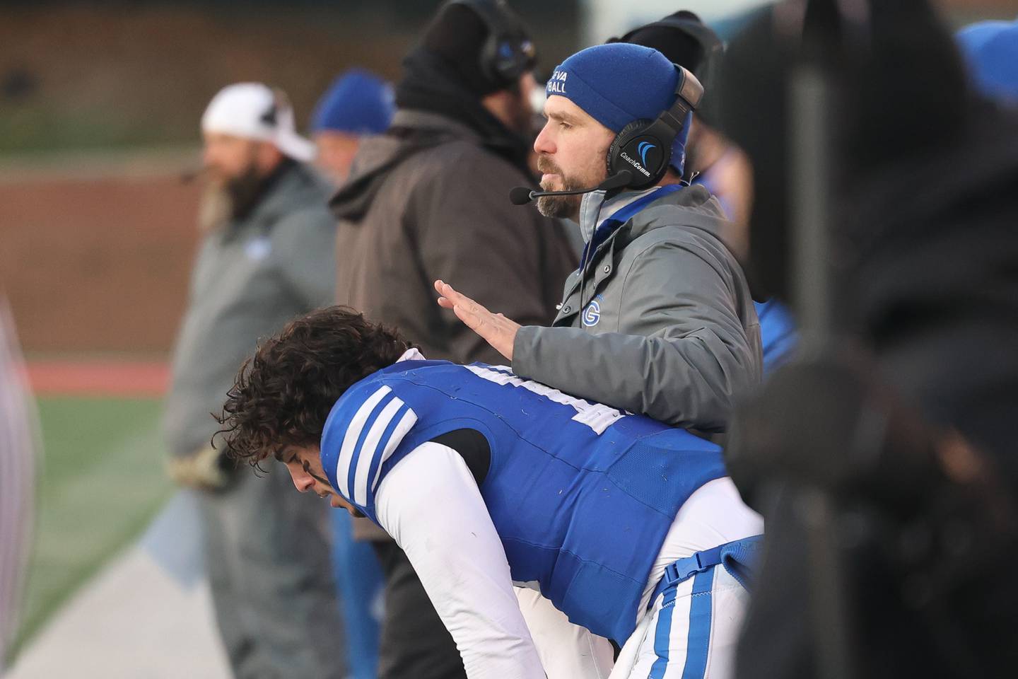 Geneva head coach Boone Thorgesen consoles Anthony Chahino on the sidelines after throwing an interception against East St. Louis in the Class 6A state championship on Saturday, Nov. 30, 2024 in Normal.