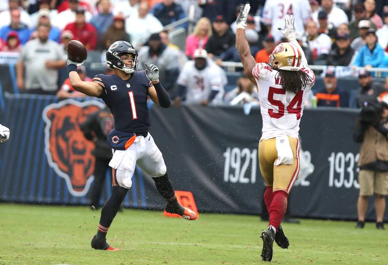 Chicago Bears quarterback Justin Fields throws the ball over the top of San Francisco 49ers linebacker Fred Warner during their game Sunday, Sept. 11, 2022, at Soldier Field in Chicago.