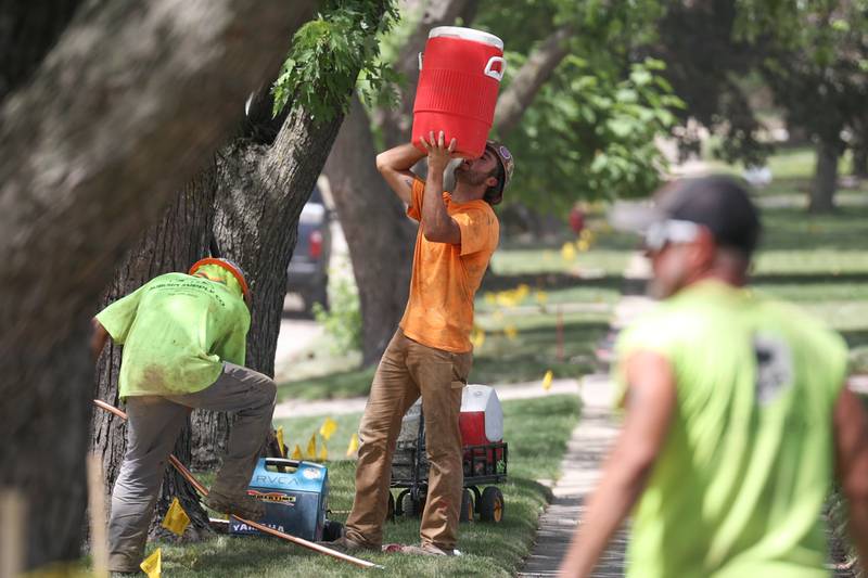 A construction worker along Edgerton Road in Joliet finds refuge in the shade to take a drink of water. The heat index put temperatures in triple digits for the second day in a row. Wednesday, June 14, 2022 in Joliet.