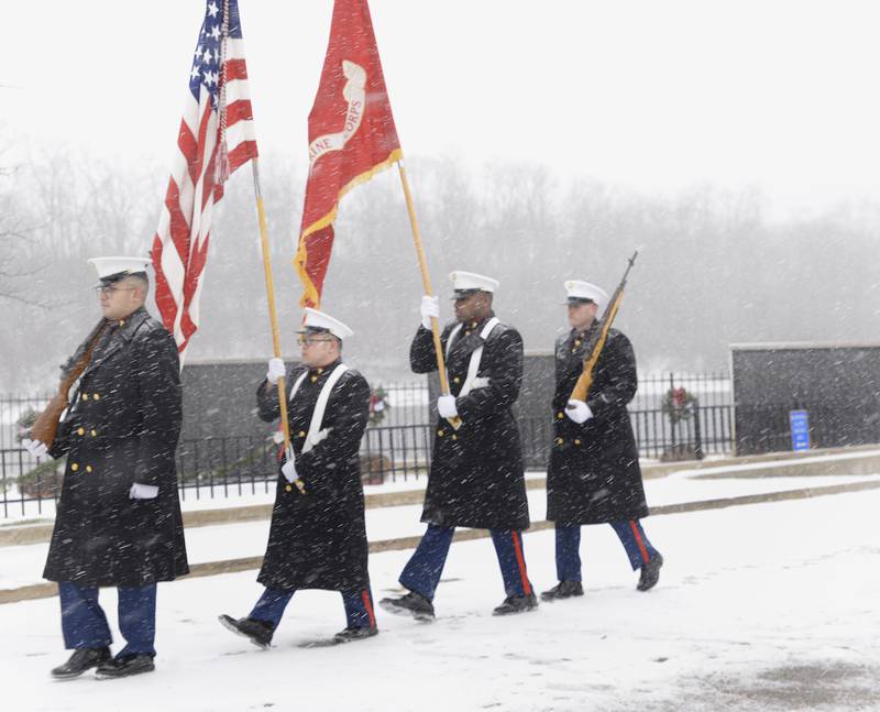 U.S. Marine Corps Color Guard unit out of Joliet, marches along the Middle East Conflicts Wall Memorial in Marseilles Saturday to post the colors during the Wreaths Across America ceremony.