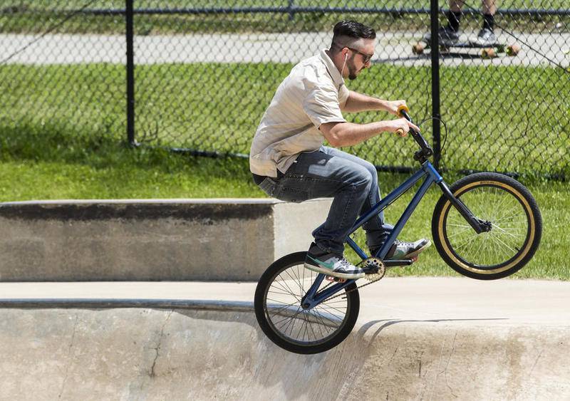 Collin Saunders, 23, of McHenry performs tricks while riding Saturday at the McHenry Zone Skate & Bike Park. Saunders has started a petition to bring back the wooden section that was demolished by the city in 2010.