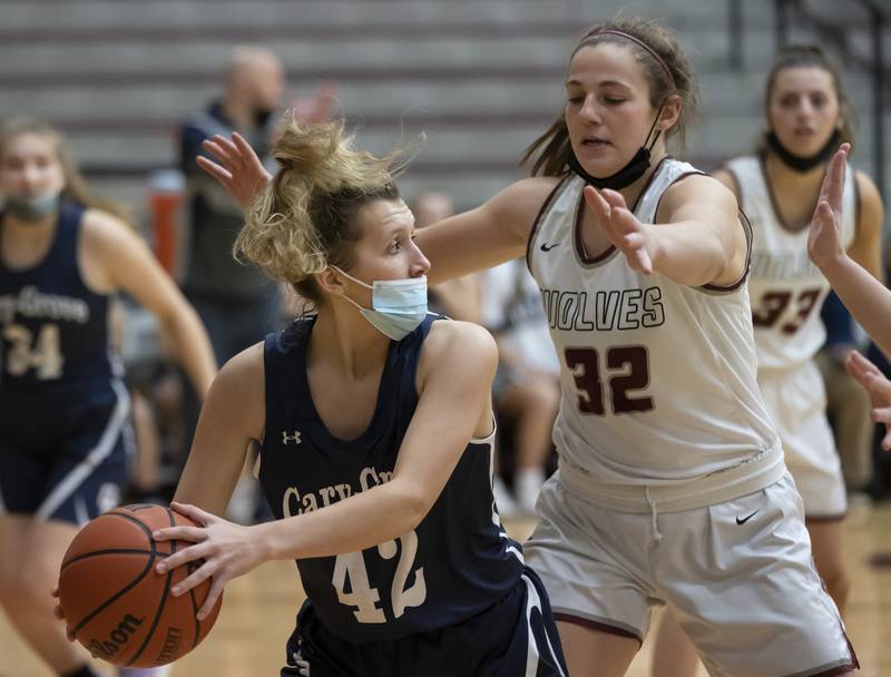 Cary-Grove's Emily Lukowski looks to pass around Prairie Ridge's Kelly Gende during their game on Wednesday, January 19, 2022 at Prairie Ridge High School in Crystal Lake.