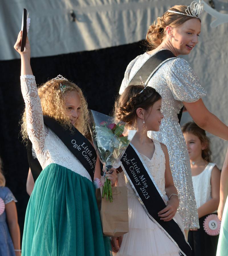 Talia Pope, 7, of Oregon, (left) looks to her family in the crowd after being named 2024 Little Miss at the Ogle County Fair Pageant on Wednesday, July 31, 2024