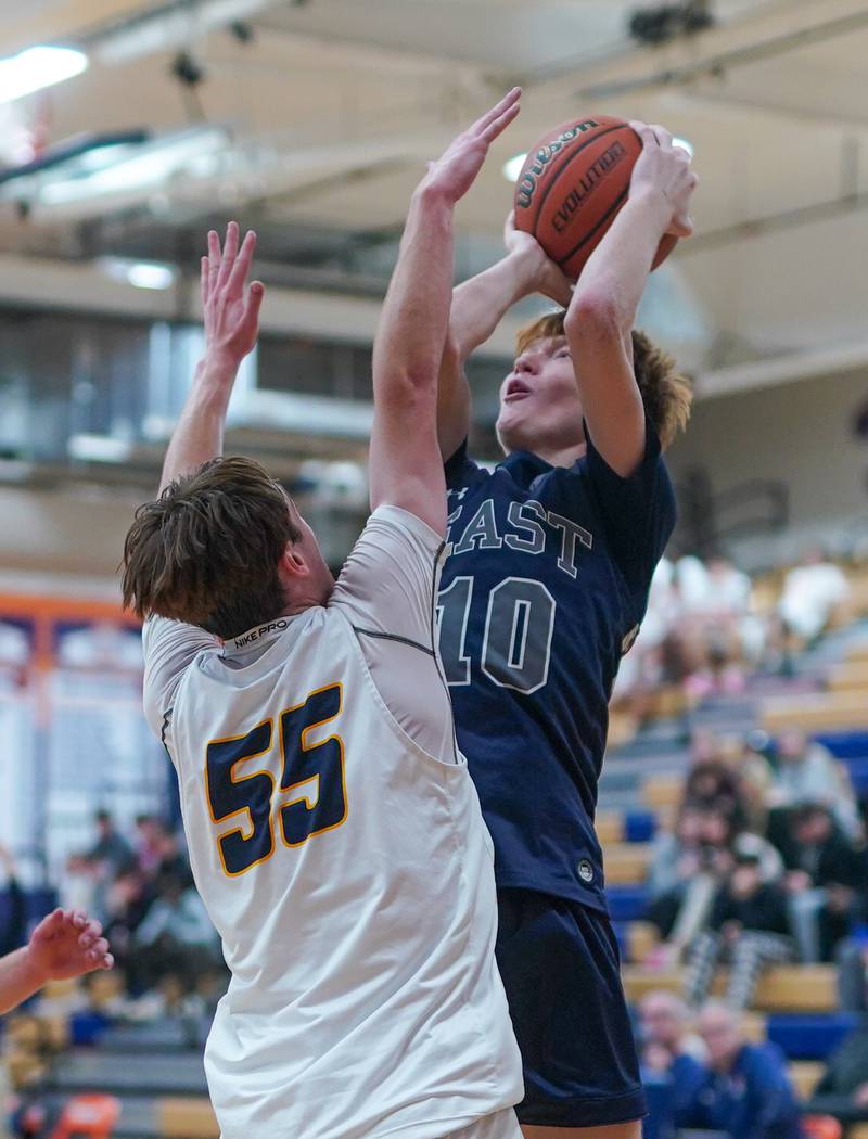 Oswego East's Noah Mason (10) shoots the ball in the post against Neuqua Valley's John Bieber (55) during a hoops for healing basketball tournament game at Oswego High School on Friday, Nov 24, 2023.