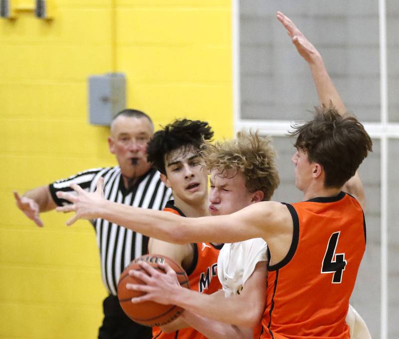 Jacobs' Max Fessler tries to break through the double team of McHenry's Marko Visnjevac and Dylan Hurckes during a Fox Valley Conference boys basketball game on Wednesday, Nov. 29, 2023, at Jacobs High School in Algonquin.