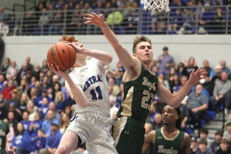 Burlington Central’s Patrick Shell, left, works under the hoop as Rockford Boylan’s Johnny.Kerestes defends in IHSA Class 3A Sectional action at Burlington Central High School Wednesday night.