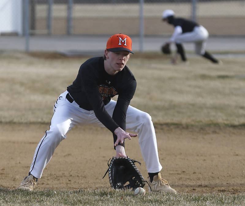 McHenry baseball player Aiden Wasik fields a hit to first base during baseball practice Wednesday, March 8, 2023, at Petersen Park in McHenry.
