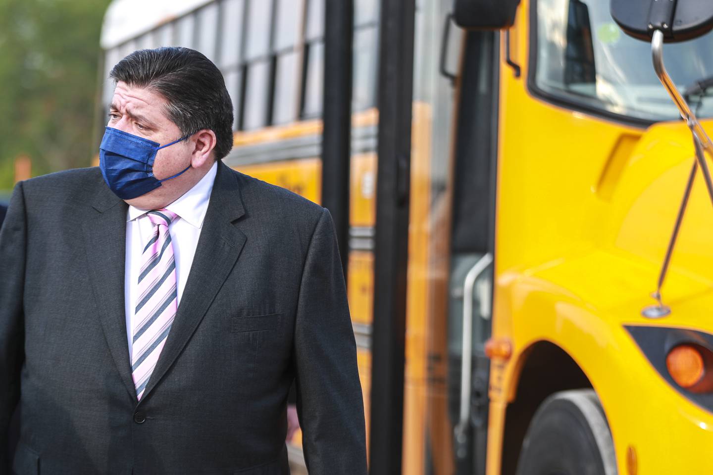 Governor JB Pritzker waits to address media on Friday, May 7, 2021, at the site of the future Lion Electric plant in Joliet, Ill.