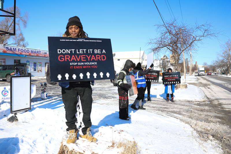 Residents holds signs along Richards Street for an Illinois Youth & Family Services anti violence rally on Monday, Jan. 26, 2026 in Joliet.