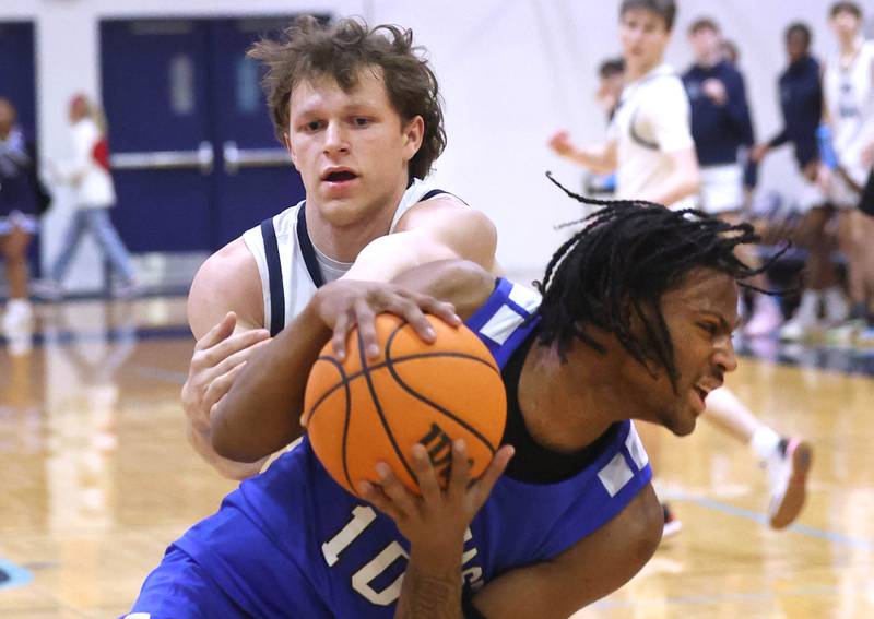 Downers Grove South's Daniel Laurich and Proviso East's Anthony Anderson fight for possession during their game Friday, Feb. 14, 2025, at Downers Grove South High School.
