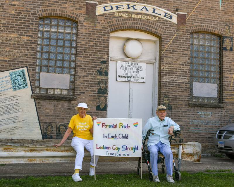 Mary Lu Strack and husband Jeff Strack of DeKalb stop by Memorial Park in DeKalb on Sunday, June 22, 2025, during a Trans Resilience Rally. The couple brought what they said was a 40-year-old sign they made to express "parental pride in each child," which they said has traveled with them to pro-LGBTQ+ rallies in Chicago and Germany.
