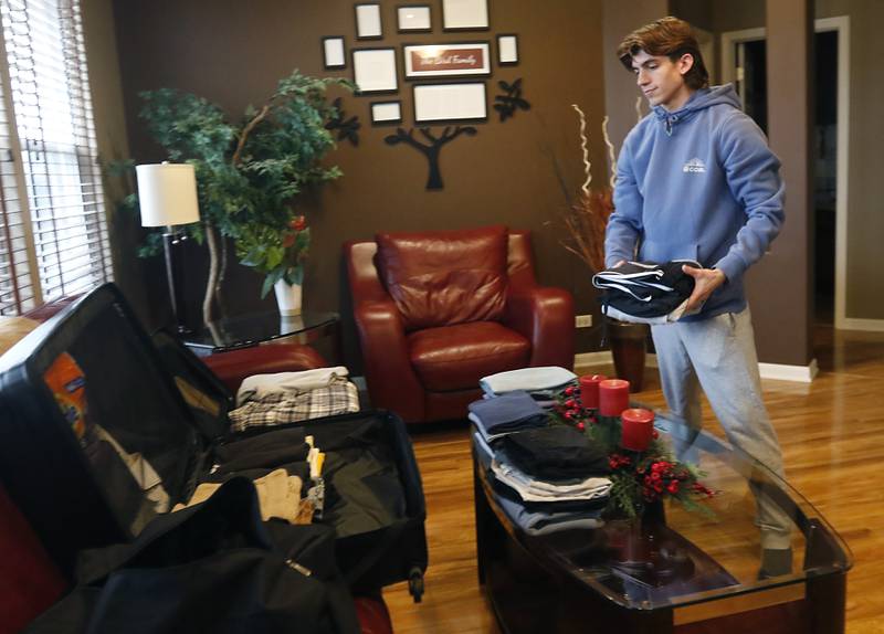Brady Bird puts clothes in his suitcase Thursday, Jan. 19, 2023, at his home in Lake in the Hills as he packs to travel to Canterbury Christ Church University in Canterbury, England. Bird is going to be McHenry County College's first study abroad student since March 2020.