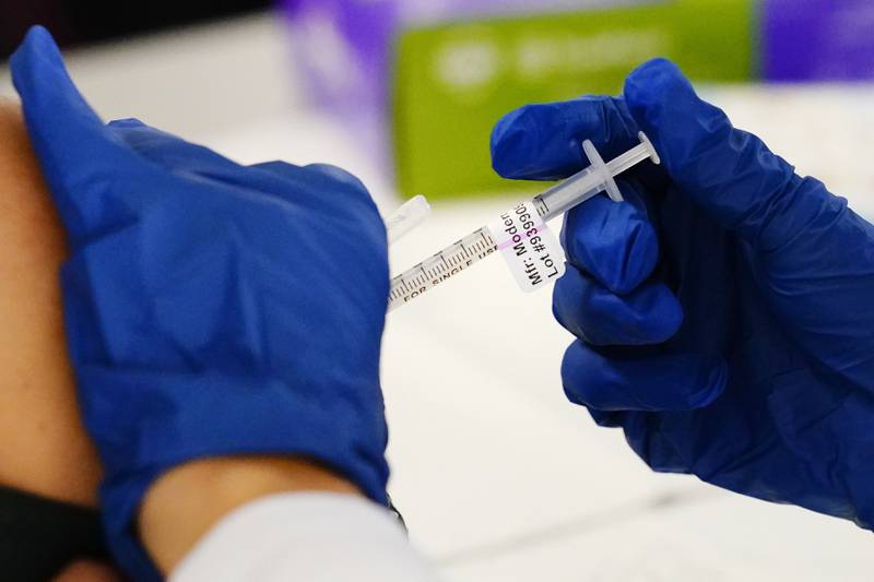 FILE - A health worker administers a dose of a Moderna COVID-19 vaccine during a vaccination clinic in Norristown, Pa., Tuesday, Dec. 7, 2021.  Moderna on Thursday, April 28, 2022,  asked U.S. regulators to authorize low doses of its COVID-19 vaccine for children younger than 6, a long-awaited move toward potentially opening shots for millions of tots by summer.(AP Photo/Matt Rourke, File)