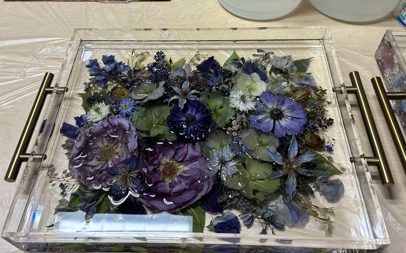 Dried flowers from a wedding arrangement at Bupp Woodworks & Designs on Nov. 28, 2025. The McHenry-based business encase the flowers in resin to preserve them.