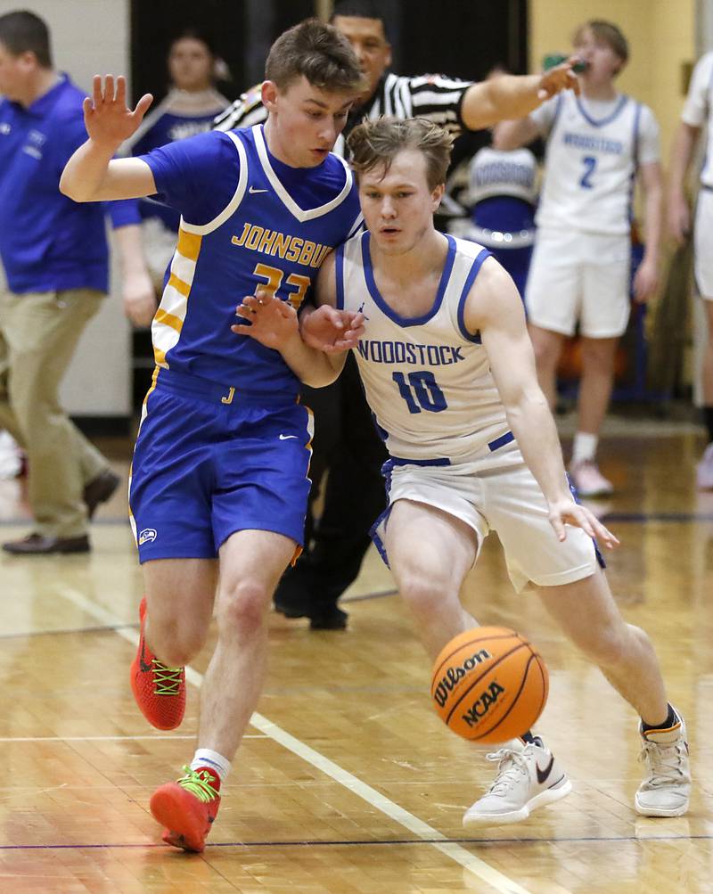 Woodstock's John Canty (right) brings the ball up the court against Johnsburg's JT Schmitt during a Kishwaukee River Conference basketball game on Friday,  Feb. 14, 2025, at Woodstock High School.