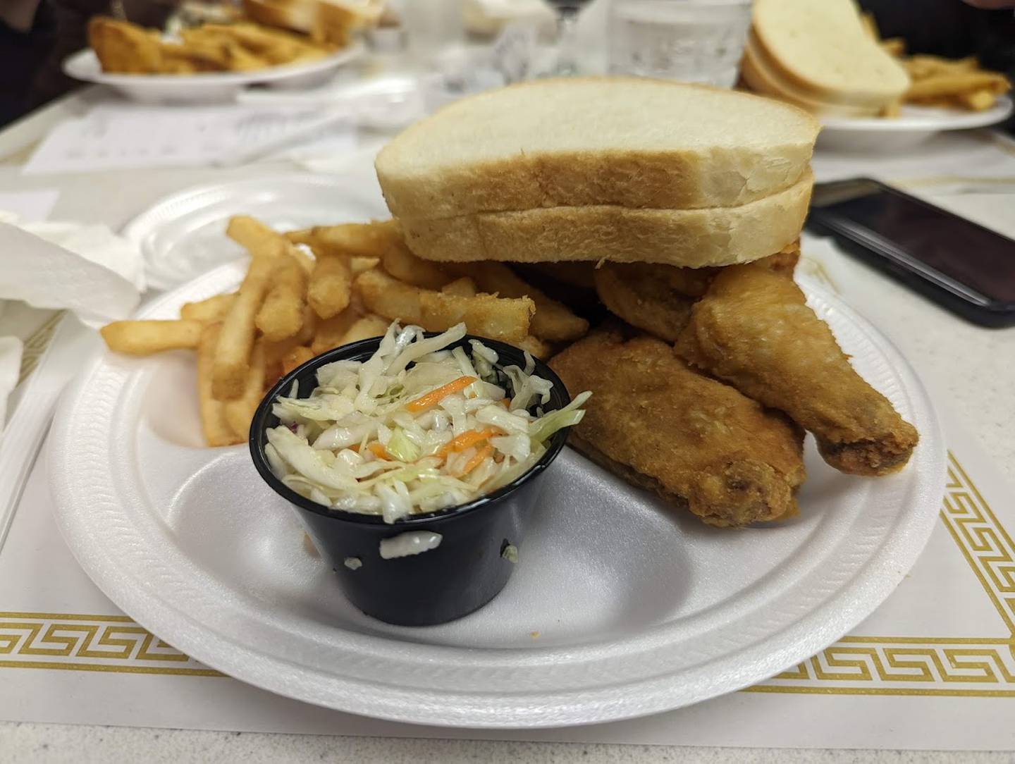 Pictured is the half chicken dinner at the Knights of Columbus Holy Trinity Council No. 4400 on Joliet's East side. The dinner came with battered fries, vinegar cole slaw and two slices of bread.