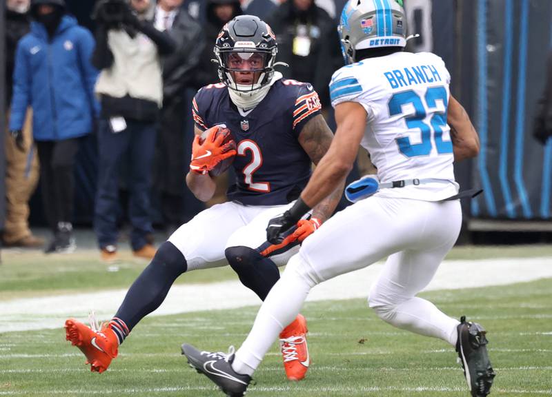 Chicago Bears wide receiver DJ Moore looks to get by Detroit Lions safety Brian Branch during their game Sunday, Dec. 22, 2024, at Soldier Field in Chicago.