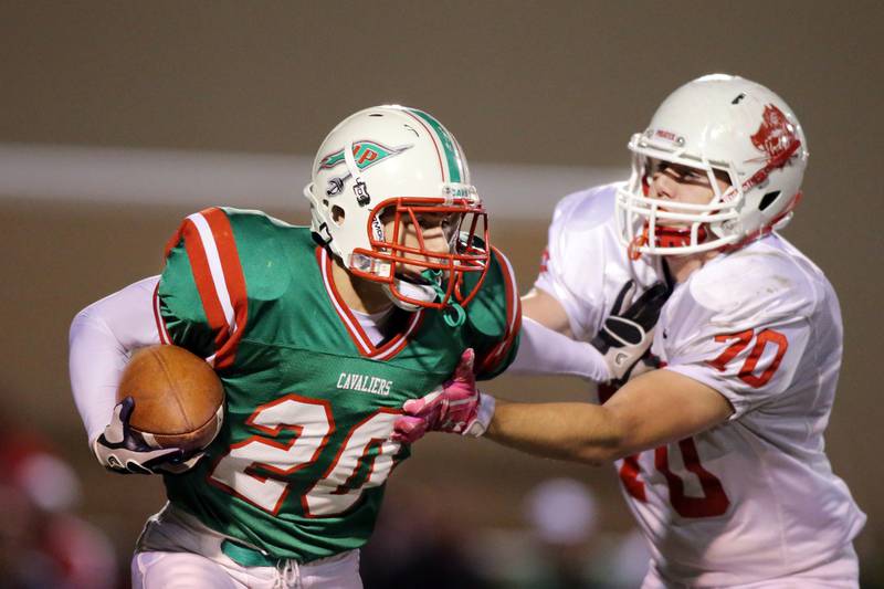 La Salle-Peru's Taylor Thompson (20) tries to break free from Ottawa's Jacob Vanda (70) during the 2012 contest at Howard Fellows Stadium.