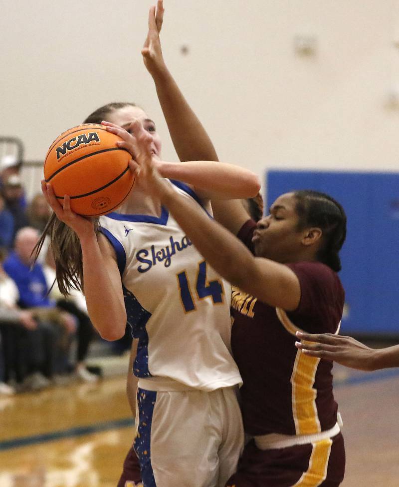 Johnsburg's Summer Toussaint tires to power up a shot against Chicago Marshall's Anabel Robinson during a IHSA Class 2A Johnsburg Sectional girls basketball semifinal game on Tuesday, February, 24, 2026, at Johnsburg High School.