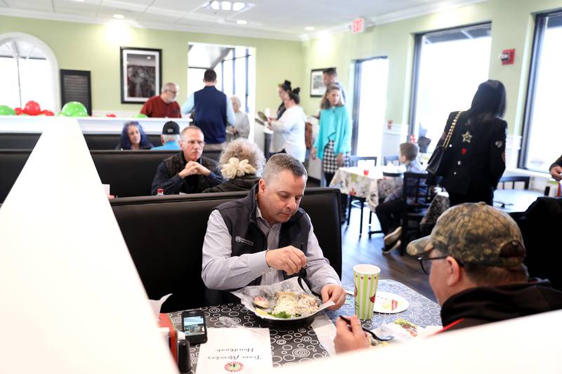 Jon Green of Batavia digs into his lunch with Chris Ciappa, also of Batavia, at the new Chicken Salad Chick franchise during the store’s grand opening at 220 N. Randall Rd. in Batavia on Tuesday, Jan. 10, 2023. Green was the first person in line for the opening after arriving just after 4 a.m.