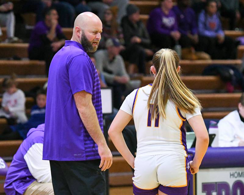 Downers Grove North's head coach Stephen Bolt talks to Downers Grove North's Abigail Gross (11) while Downers Grove North's Elizabeth Murphy shoots free throws during the game on Tuesday Dec. 3, 2024, while taking on York High School held at Downers Grove North High School.