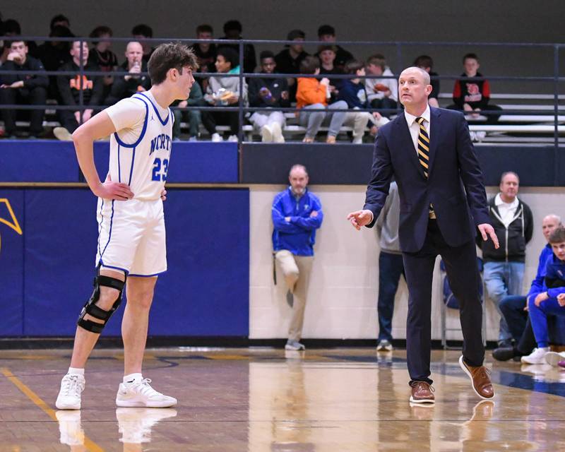 Wheaton North's head coach Dave Eaton talks with Wheaton North's Adam Schilling (23) during a break in the action on Friday Feb. 6, 2026, while taking on Wheaton Warrenville South held at Wheaton North High School.