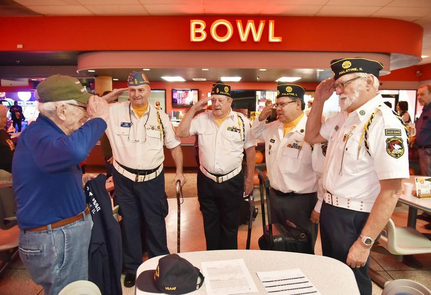 Members of the Palatine American Legion Post 690 Color Guard salute 103-year old bowler Ed Berthold of Fox River Grove, left, at Bowlero in Deer Park on Tuesday, Nov. 22, 2022. Berthold's decadeslong love affair with bowling began when he was stuck in Iceland while serving in World War II.