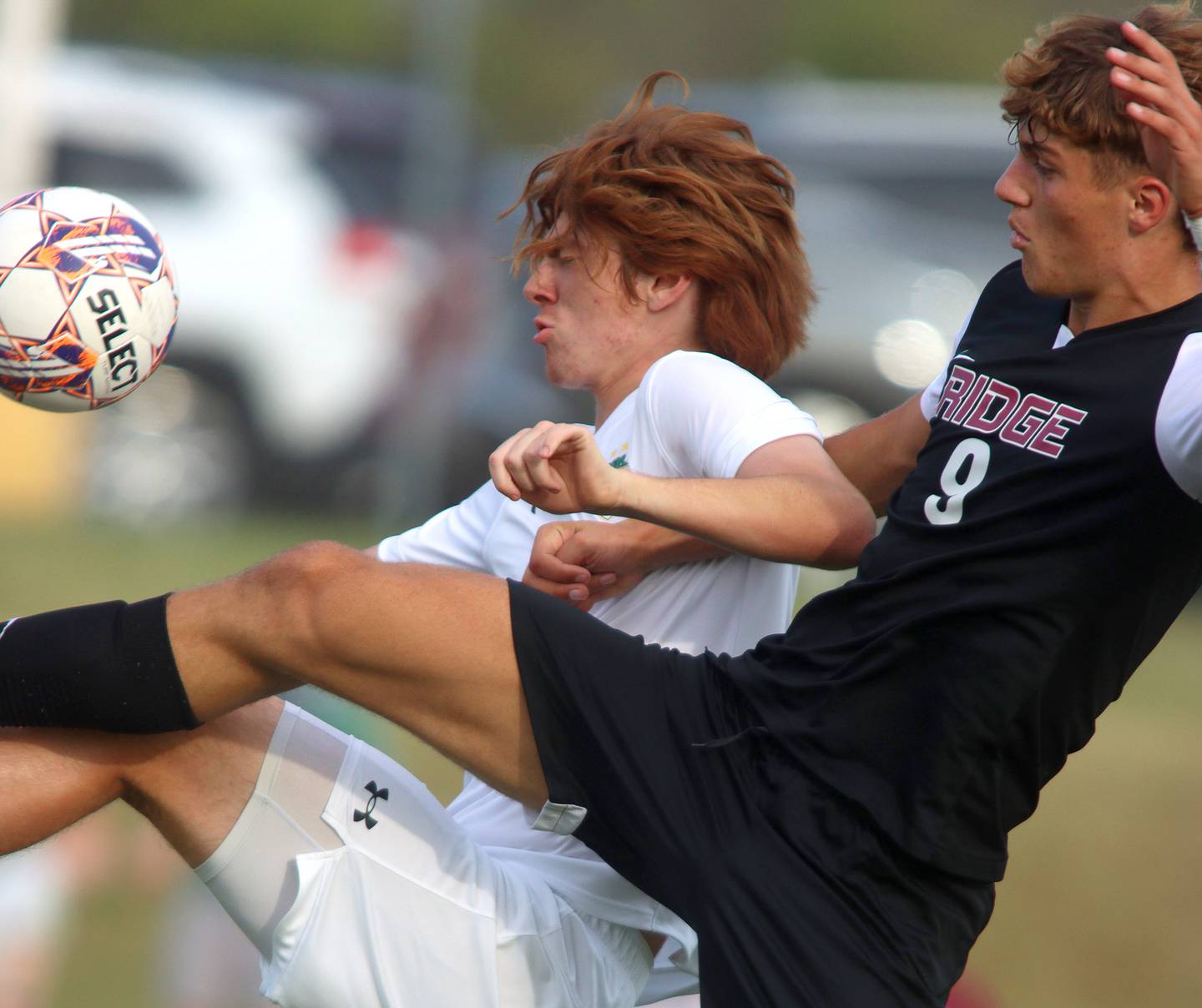 Crystal Lake South’s Pierce Johnson battles Prairie Ridge’s Henry Knoll, right, in varsity soccer on Thursday, Sept. 19, 2024, at Prairie Ridge High School in Crystal Lake.
