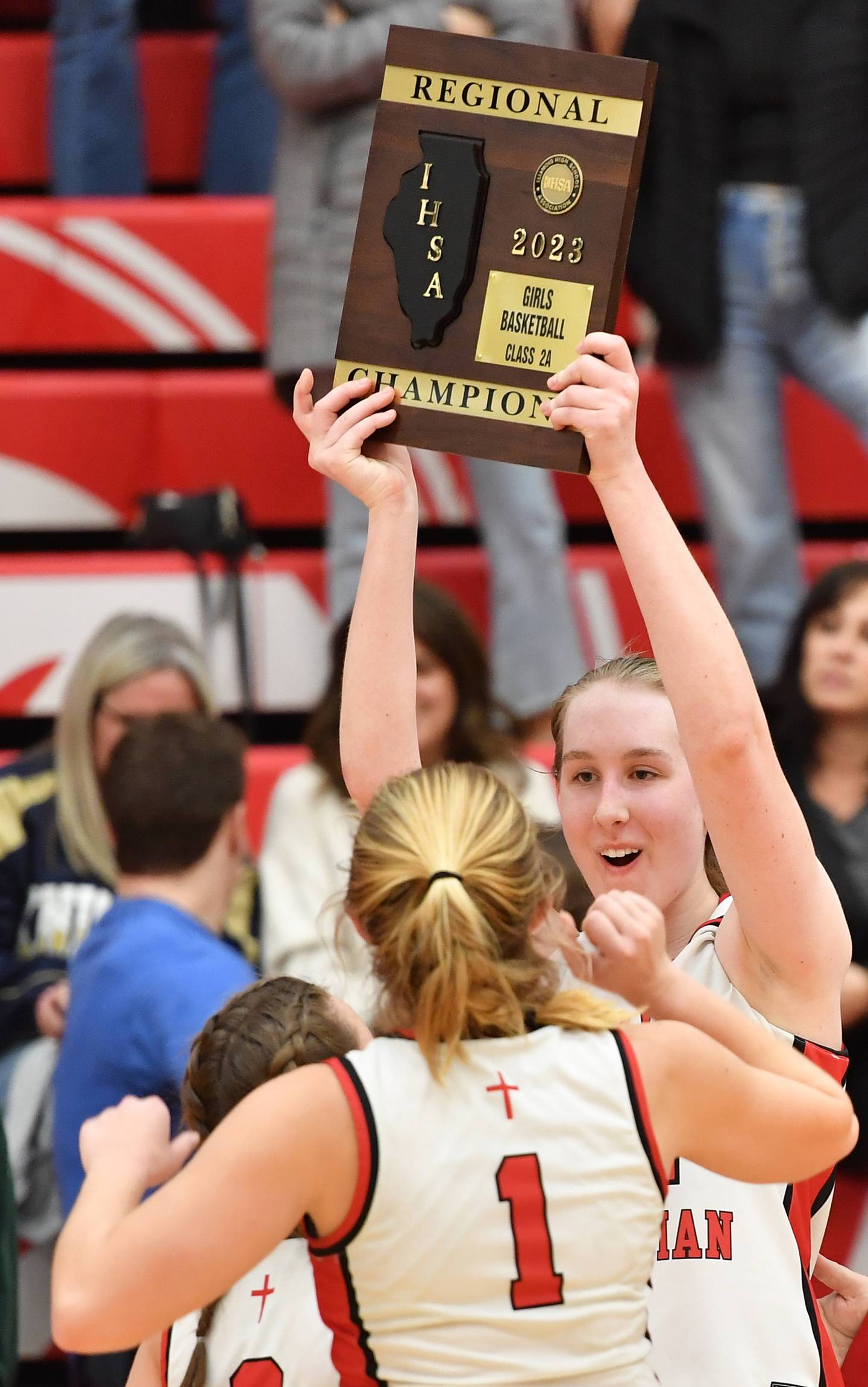 Timothy Christian's Grace Roland holds the newly won regional championship plaque aloft after the Class 2A Timothy Christian Regional championship game against IC Catholic Prep on Feb. 17, 2023 at Timothy Christian High School in Elmhurst.