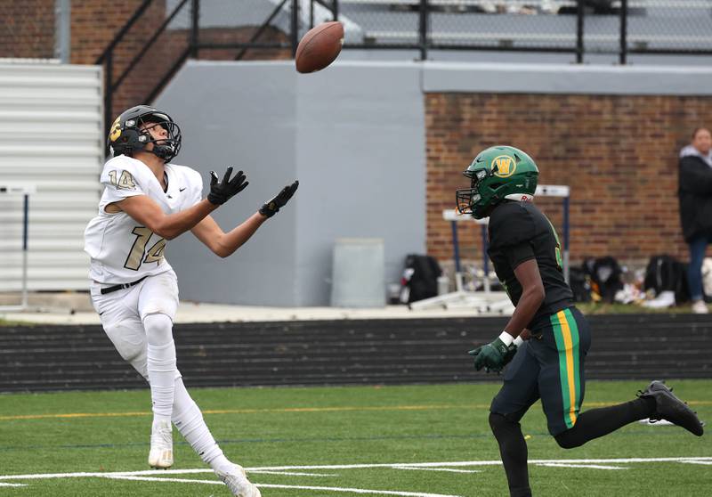 Sycamore's Josiah Mitchell catches a touchdown pass behind Westinghouse's Cornell Montgomery Saturday, Nov. 9, 2024 during their Class 5A second-round playoff game at Knute Rockne Stadium in Chicago.