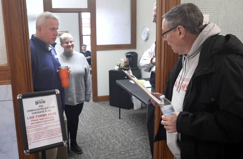 DeKalb City Council Ward 5 alderman Scott McAdams (right) is invited in as the first to file for candidacy by mayor Cohen Barnes and DeKalb City Council recording secretary Ruth Scott Monday, Dec. 12, 2022, at City Hall. McAdams, who is running for re-election, was the first candidate in line Monday at 8:30 a.m. when filing opened at City Hall.