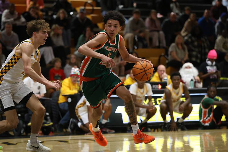 Plainfield East’s Kierre Miller works the top of the key against Joliet West on Friday, Dec. 19, 2025 in Joliet.