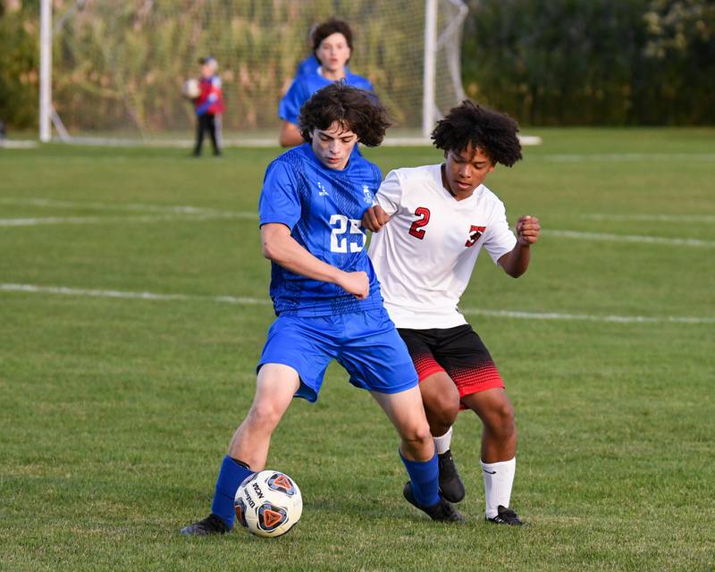 Hinckley-Big Rock's Cayden Bush, 25, and Indian Creek's Juan Sanchez battle for the ball on Monday Sept. 26th during the first half of the soccer game held at Hinckley-Big Rock High School.