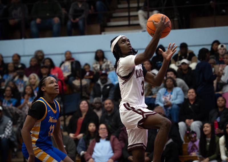 Kankakee's Cedric Terrell III elevates for a lay-up past Crete- Monee's Zhakeem Cole, left, in a game on Friday, January 9, 2026.