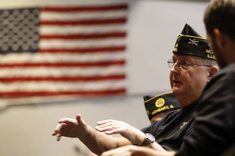 Veteran Wil Platacis speaks to students inside the auditorium at McHenry High School's Upper Campus during a Veterans Day event on Thursday, Nov. 11, 2021.