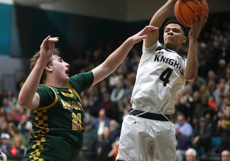 Kaneland's Brian Edwards (right) grabs a rebound in front of Crystal Lake South's Ryan Morgan during the IHSA Class 3A Woodstock North Sectional final basketball game on Friday, March 6, 2026, at Woodstock North High School.