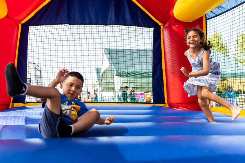 Emanuel and Elianna Serna, of Hampshire, have fun in a bounce house during Barro Fest at Settlers' Park in Plainfield on July 27, 2024.