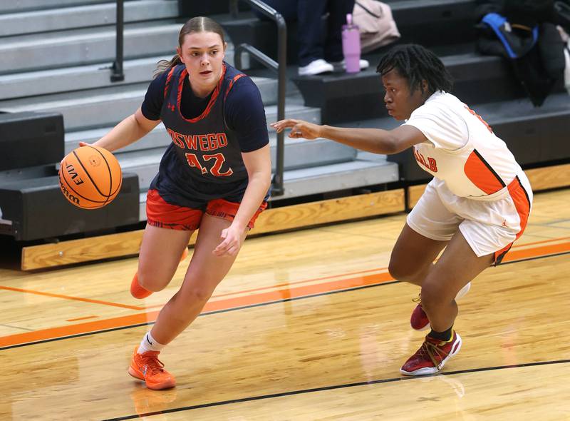 Oswego's Kendall Grant goes to the basket against DeKalb's Angela Gary during their game Monday, Jan. 5, 2026, at DeKalb High School.