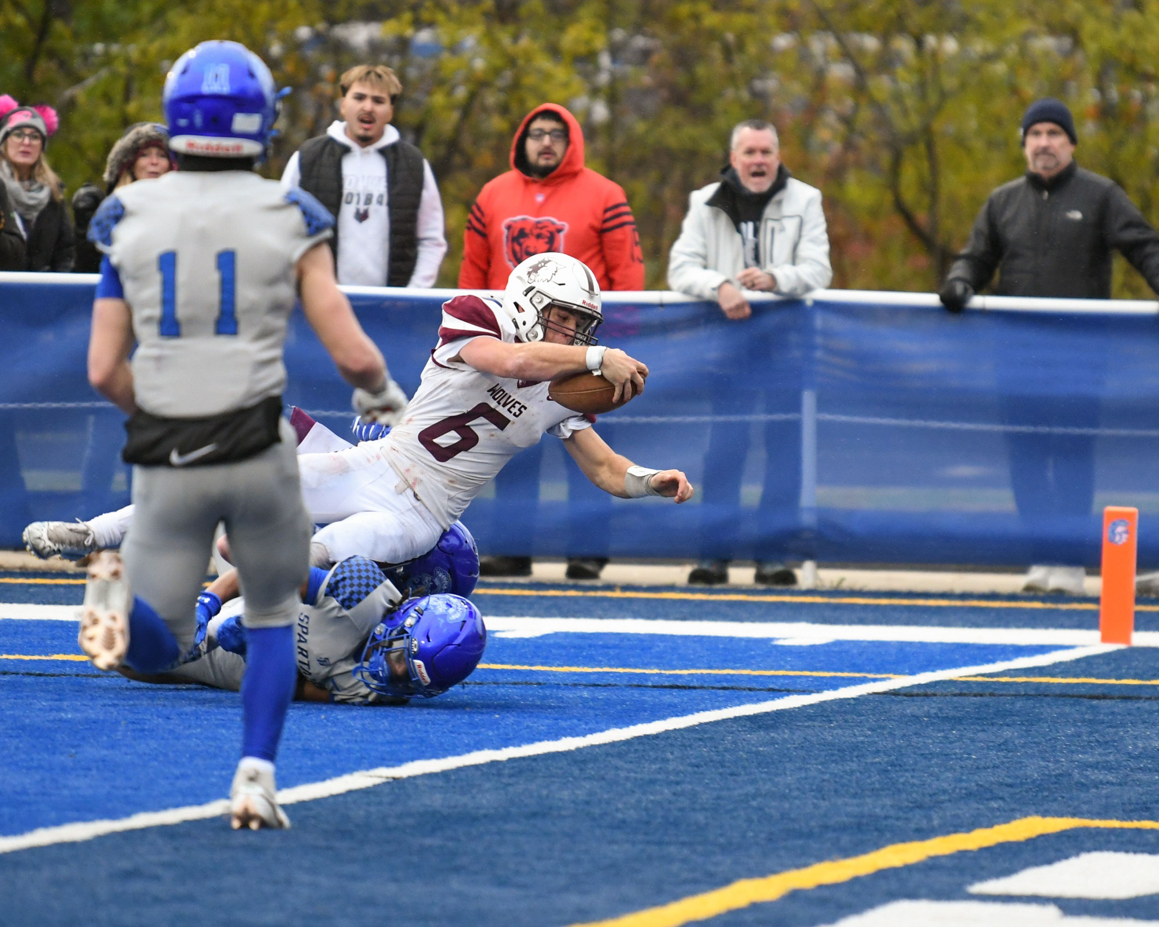 Prairie Ridge's Luke Vanderwiel (6) falls into the endzone while being defended by St. Francis’s defenders during the second round of the 5A playoff game on Saturday Nov. 8, 2025, held at St. Francis's High School.